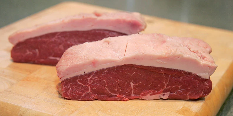 Raw picanha steaks showing the distinctive fat cap